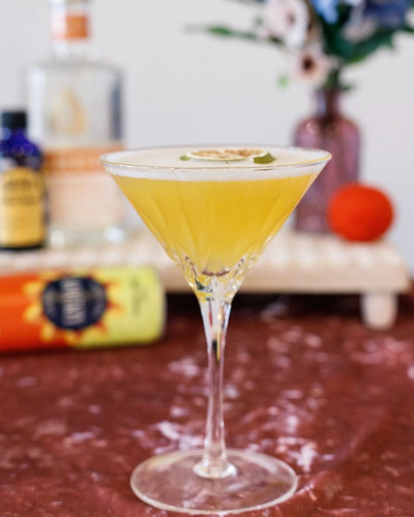 bright yellow drink in a martini glass