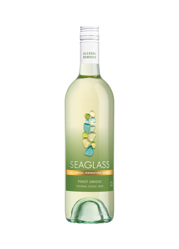 A bottle of Seaglass Alcohol Removed Pinot Grigio wine on a solid white background. The bottle is clear glass showing the pale yellow-green wine inside, with a green label featuring a graphic of stacked stones and an orange accent band.